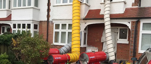 front side of the apartment building with industrial fans connected to flex ducts
